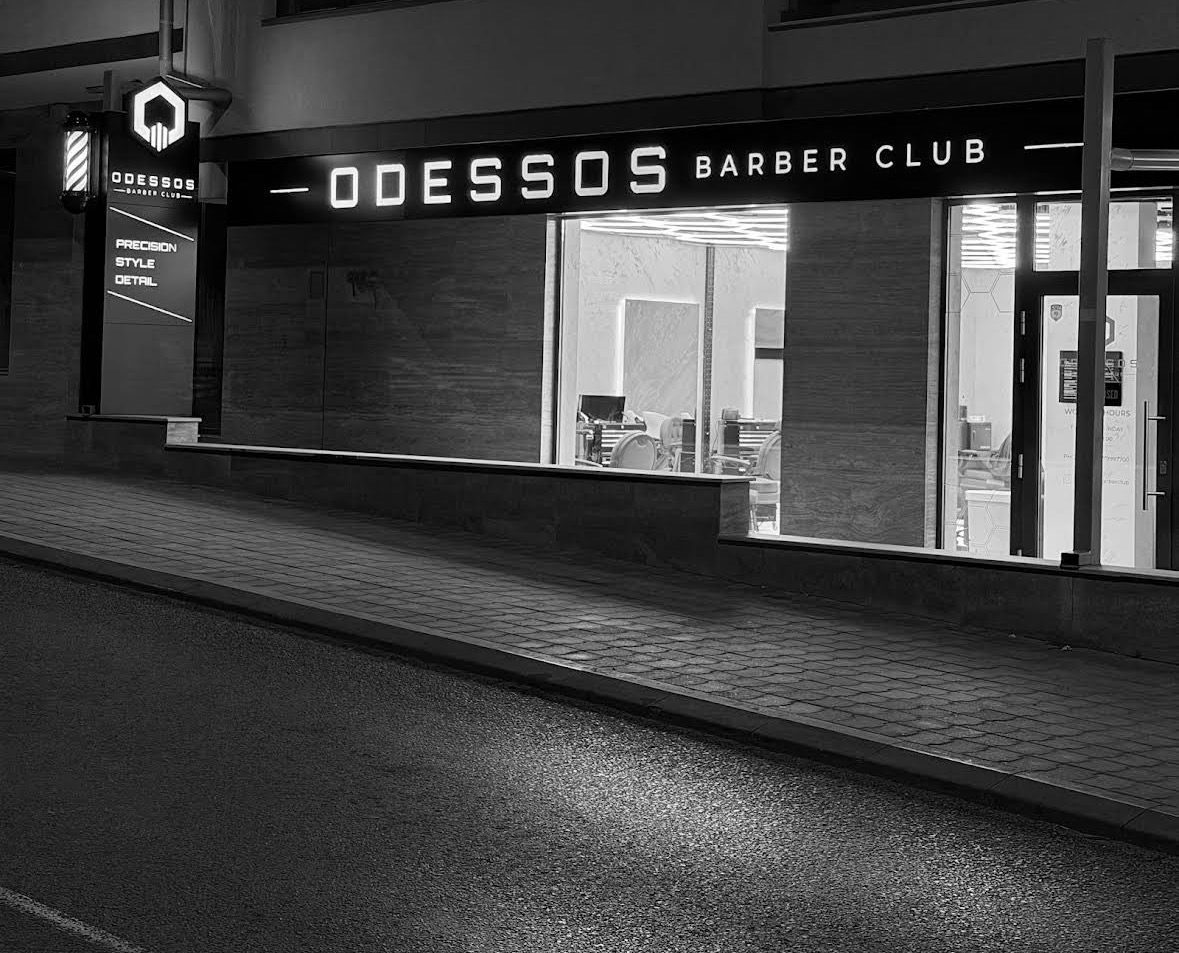 Odessos Barber Club night storefront with illuminated signage
